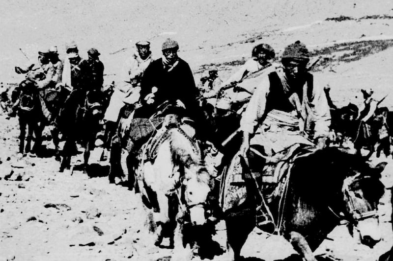 In this March 21, 1959 photo, the Dalai Lama and his escape party on the fourth day of their flight to freedom as they cross the Zsagola pass, in southern Tibet, while being pursued by Chinese military forces, after fleeing Lhasa. The then-23-year-old Dalai Lama is aboard the white horse.