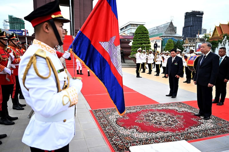 Vietnam's President To Lam, front right, and Cambodia's Defense Minister Tea Seiha, back right, pay their respects in front of honor guards at the Independence Monument in Phnom Penh on July 13, 2024. (Tang Chhin Sothy/AFP)