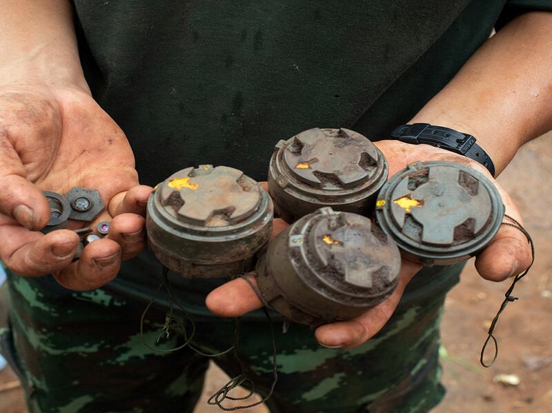 A member of the anti-junta Karenni Nationalities Defence Force holds landmines planted by the Myanmar military and removed during demining operations near Pekon township, July 11, 2023.