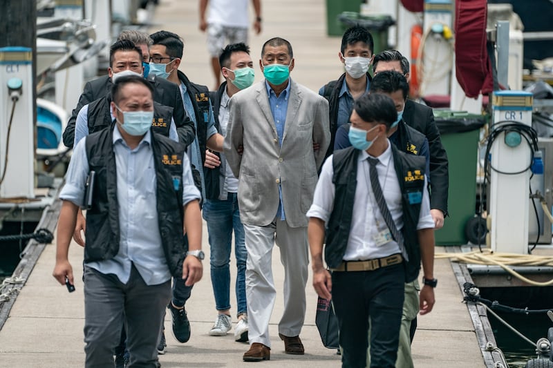 Hong Kong media tycoon and Apple Daily founder Jimmy Lai is escorted by the police for evidence collection on Aug. 11, 2020 in Hong Kong.