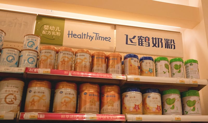 Feihe milk powders are displayed on shelves in a store in Shanghai, April 3, 2023.
